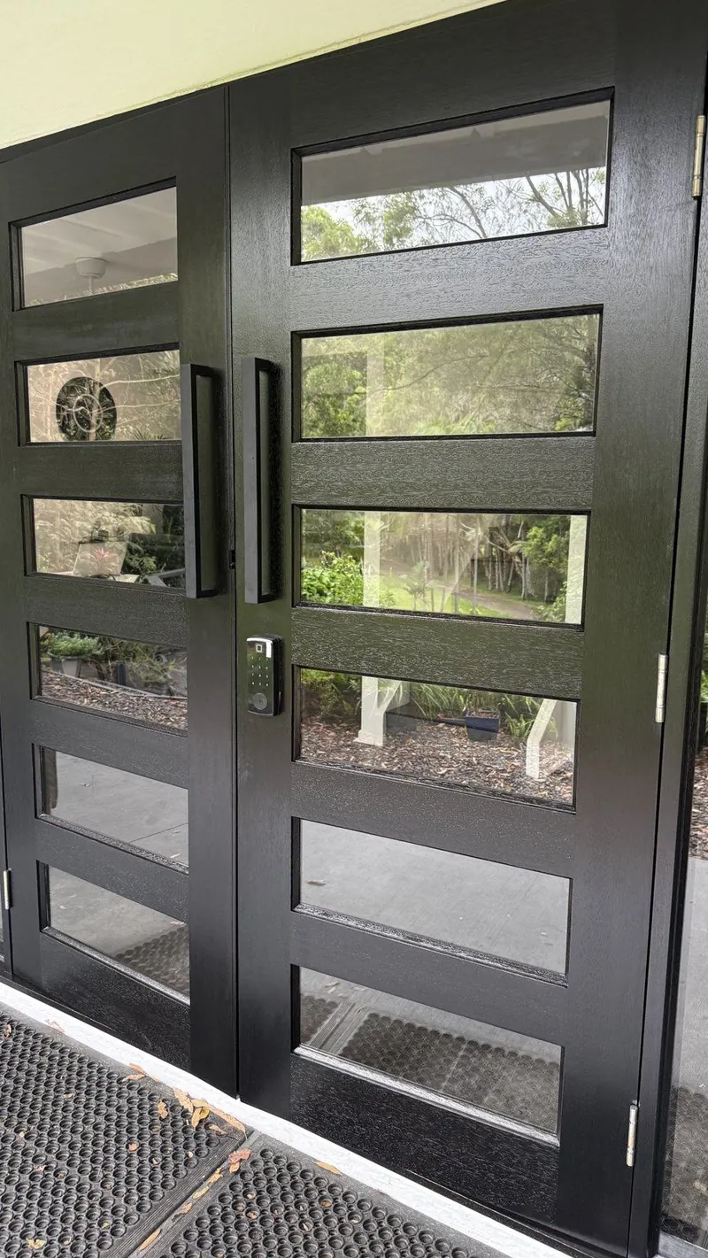 Black timber entry doors with glass panels
