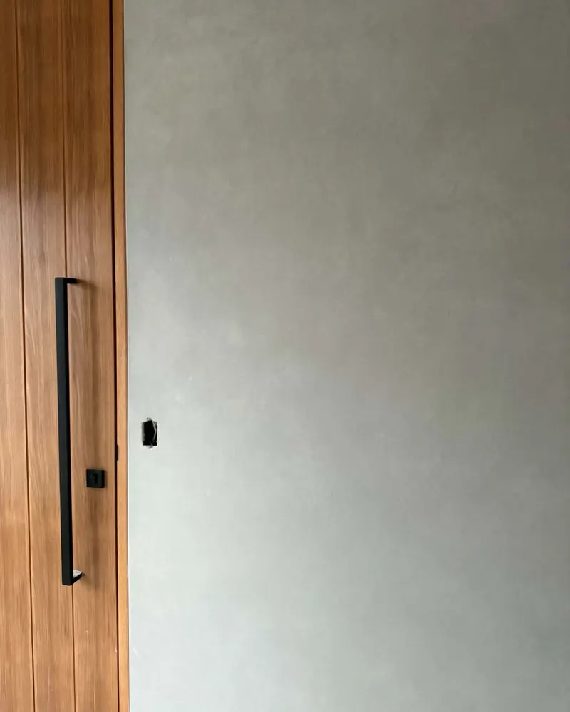 French wash finish on a feature wall beside a timber entry door