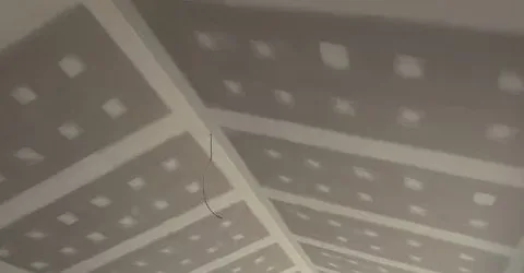 Pitched plasterboard ceiling with joints and fixings set, ready for sanding